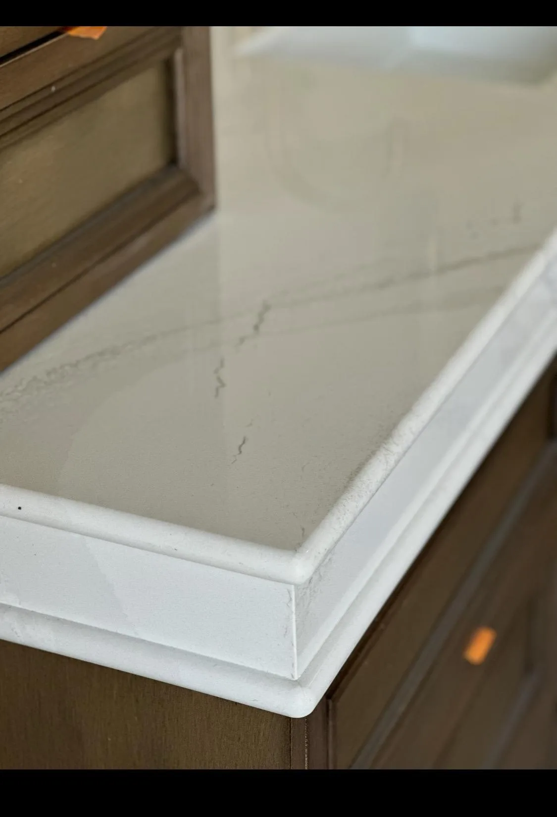 Close detail of a custom pencil edge profile on a stone countertop