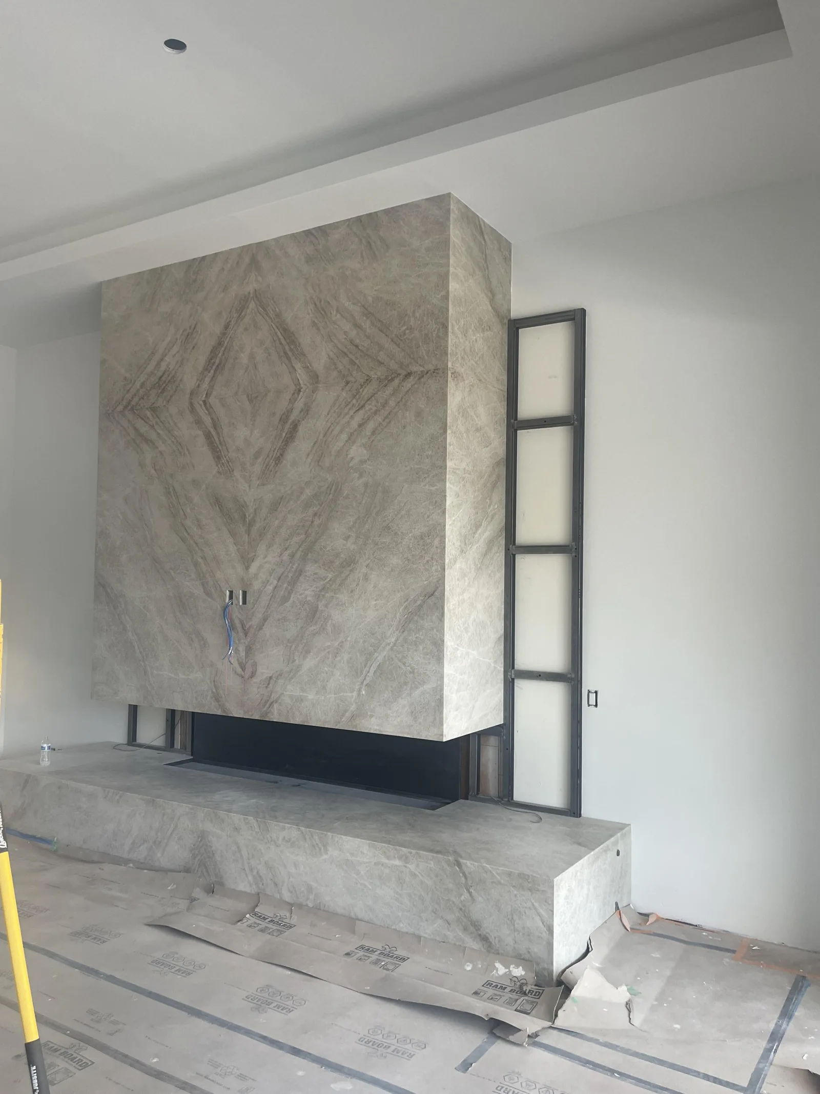 Custom fireplace surround made from Taj Mahal natural stone